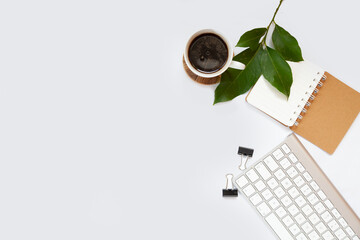 Office table top. Workspace with blank board with clip, keyboard, stationery, pencil, coffee cups on light gray background. Place for text