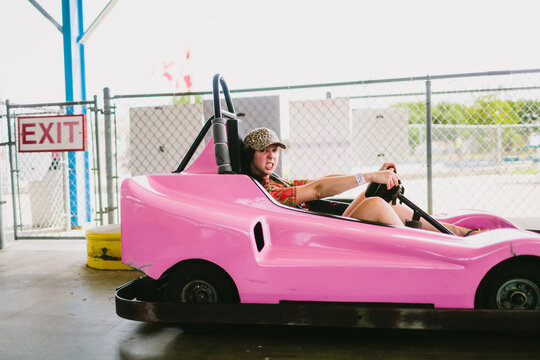 Young woman snarls as she rides her go-cart