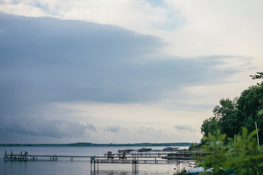 Dark Stormy Clouds with Silver Lining Over Calm Lake