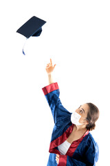 A girl wearing a surgical face mask and graduation outfit.