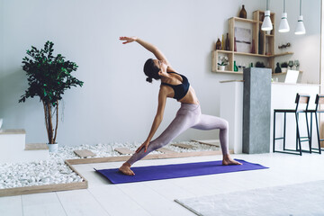 Young woman doing yoga in studio