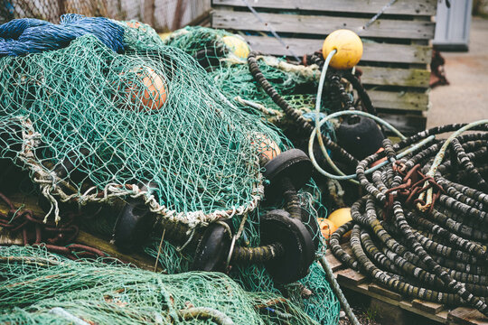 Closeup of rouged green fishing nets and other fishing equipment