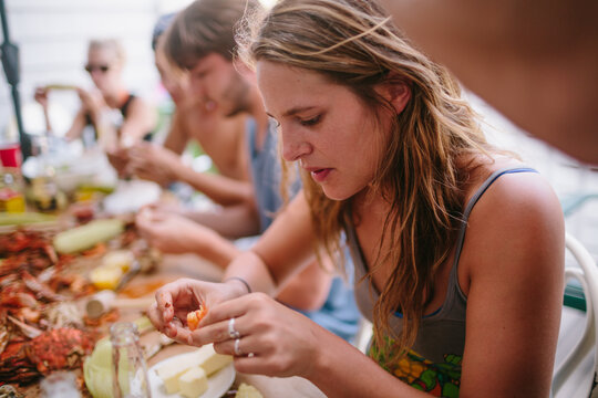 Young woman eating crab on Maryland coast