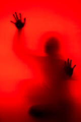 Silhouette of a woman behind the glass