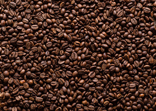 Texture of brown roasted coffee beans. Background of coffee beans. Horizontal image.