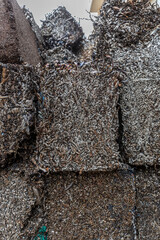 Stacks of compressed metal shavings blocks at recycling yard