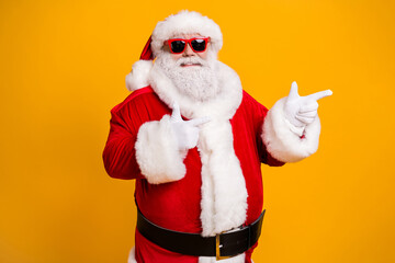 Fototapeta na wymiar Portrait of his he nice attractive cheerful confident fat Santa demonstrating copy empty blank place space way direction choose choice isolated over bright vivid shine vibrant yellow color background