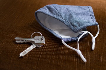 covid mask and keys on the table