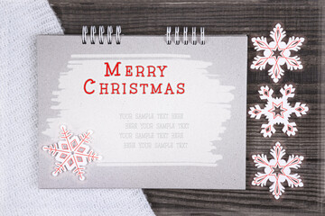 Christmas card with congratulations text on a notebook with a place for an inscription