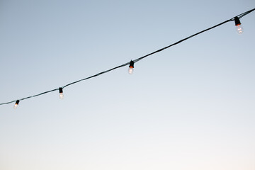 String of twinkle lights against sky