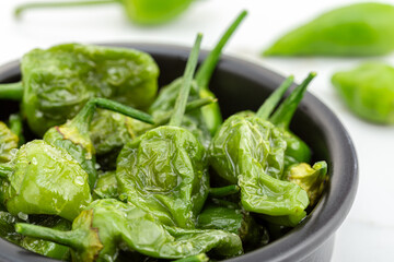 Cooked Padron peppers with olive oil and sea salt. Traditional Spanish tapas