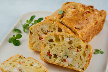 Chicken, cheese and pepper muffin on light grey background. Savory muffin. Healthy lunch or snack.