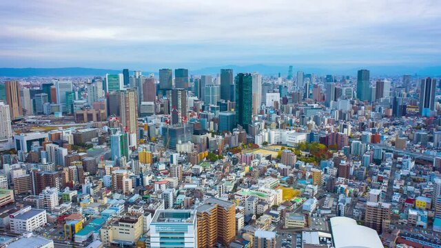 Aerial view Hyper lapse 4k footage of car on highway and Building in Osaka city, Japan. 