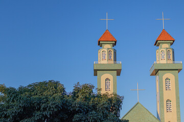church in brazil with beautiful images of cross and faith catholic church with beautiful architecture and clear skies with trees and vegetation as a tourist spot church faith devotion