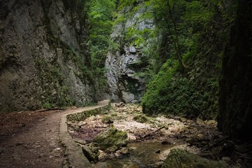An hiking path in a gorge among the rocks in the Sibillini mountains (Marche, Italy, Europe)