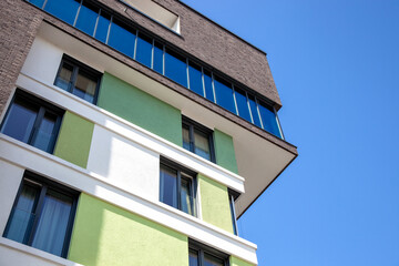 colorful facade of the new city apartments building. corner apartment complex. Modern architecture, residential building