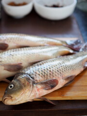 Fresh carp on a wooden rustic table