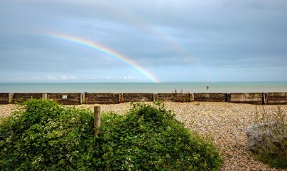 rainbow over the sea behind a pebble beach in dover