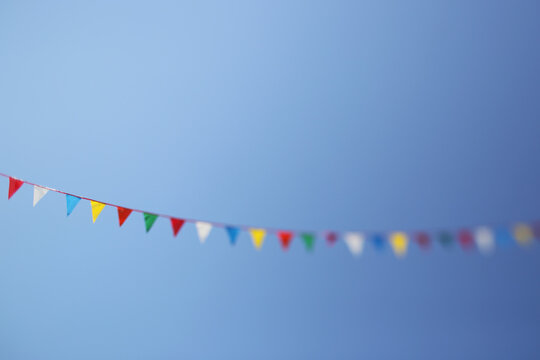Festive Flags Hanging Outside On A Clear Summer Day