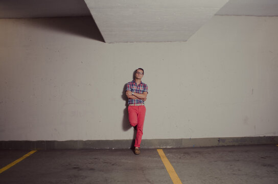 Young stylist man standing in a parking lot
