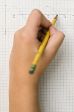 blurred hand drawing graph on paper