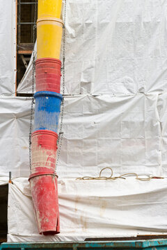 Construction site with plastic tarp and rubble chute