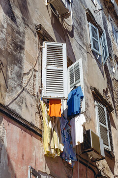Laundry dring form a window with shutters in a Venetian style building