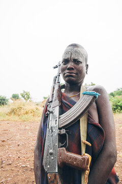 Mursi tribe African man with AK47 rifle. Mago National Park, Ethiopia