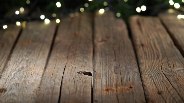 Old wooden table background, Christmas lights bokeh