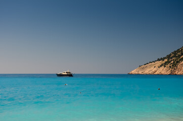 Fototapeta na wymiar An yacht on the Ionian Sea, near Myrtos beach, in Kefalonia, Greece