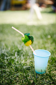 Blue plastic glass with pineapple sipper