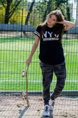 girls gna skateboard near the sports ground