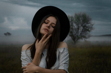 girl on the street in a black hat