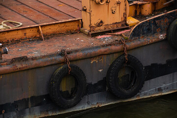 Fototapeta na wymiar Old rusty ship with buoy tires