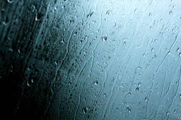 Foggy glass with falling drops