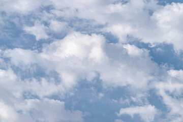 White fluffy clouds in a blue sky, background and pattern
