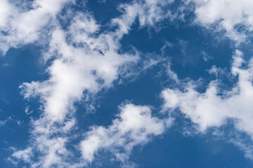 Blue sky and white and fluffy clouds, background and pattern