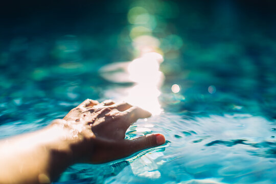 A man's hand on the water