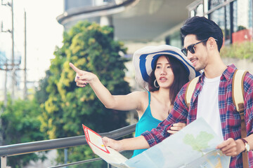 Asia people tourist man and women sightseeing city with map.  Lifestyle traveler looking and...