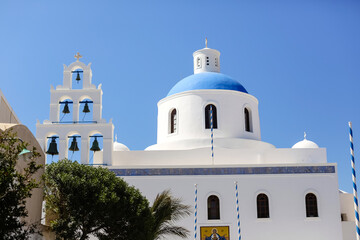 The Christian Church is white and blue against the sky.Cathedral in Greece on the island of Santorini.Summer travel.European architecture.selective focus