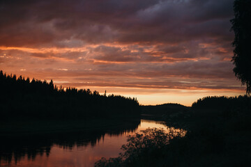 Obraz premium pink sunset over the river in the forest