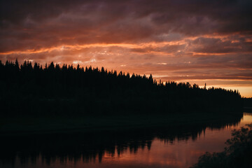 pink sunset over the river in the forest