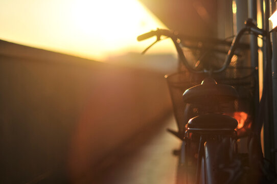 A bike parked at corridor during sunset
