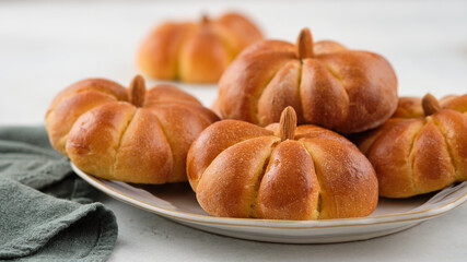 Pumpkin buns bread with spices on grey background. Halloween Food Concept. Autumn concept.