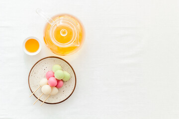 Obraz na płótnie Canvas Japanese tea and sweet dumplings Dango on plate, top view