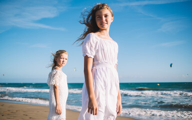 Female children enjoying summer day on beach