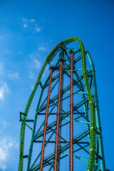 Roller coaster against a deep blue sky