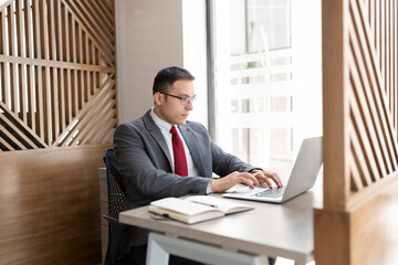 Fototapeta premium Businessman working on laptop at his desk