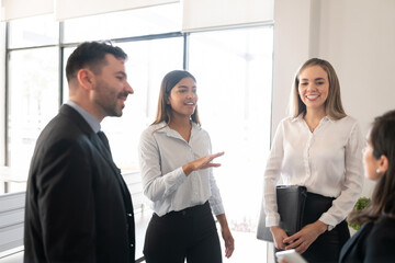 Business group discussing work in meeting
