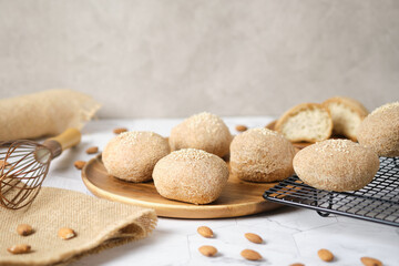 Gluten free Keto bread. Homemade ketogenic buns with sesame seeds. set on white cafe table.